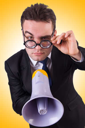 Young businessman with loudspeaker on whiteの写真素材