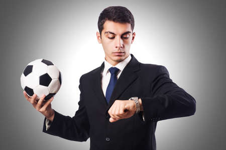Young businessman with football on whiteの写真素材