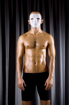 Muscular actor with theatrical maskの写真素材