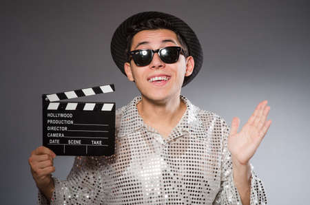 Young camera assistant with clapperboardの写真素材