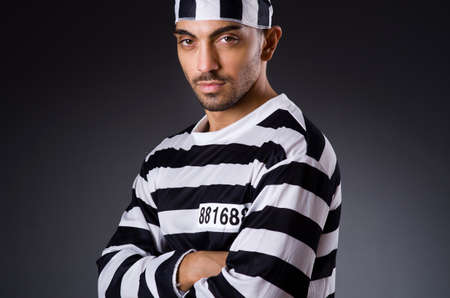 Angry prison inmate in dark room