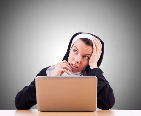 Nun working on laptop - religious conceptの写真素材