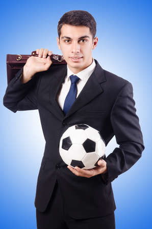 Young businessman with football on whiteの写真素材