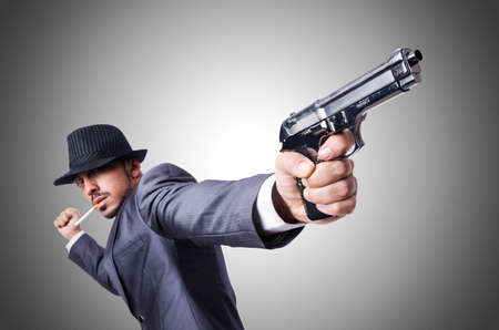 Businessman with gun isolated on white