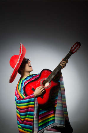 Man in red sombrero playing guitarの写真素材