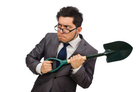 Young businessman holding a spade isolated on whiteの写真素材