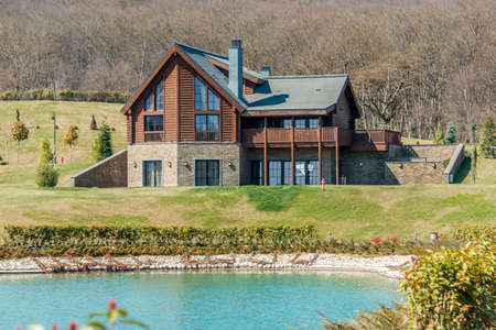 Modern house near water on bright dayのeditorial素材