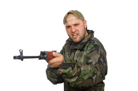 Young man in soldier uniform holding gun isolated on whiteの写真素材