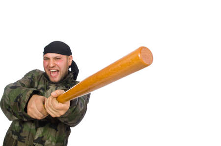 Young man in soldier uniform holding bludgeon isolated on whiteの写真素材
