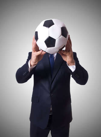 Businessman with football on whiteの写真素材