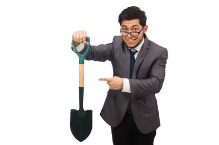 Young businessman holding a spade isolated on whiteの写真素材