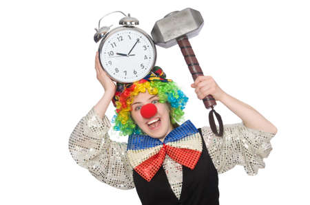 Female clown with alarm-clock and hammer isolated on whiteの写真素材