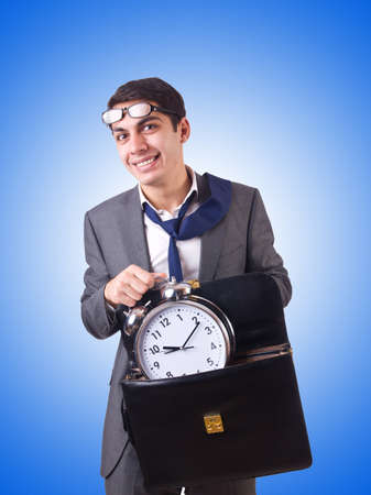 Businessman with clock isolated on whiteの写真素材