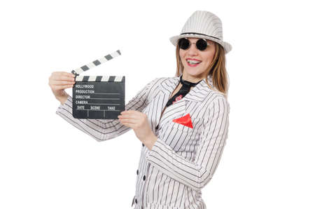 Beautiful girl in striped clothing holding clapperboard isolated on whiteの写真素材