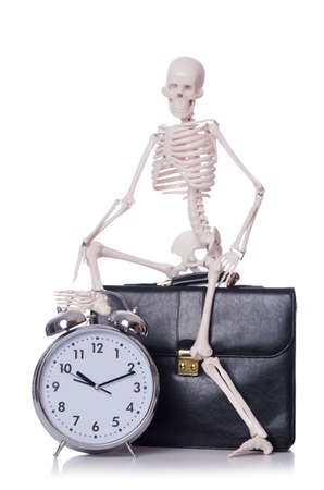 Skeleton with alarm clock on the whiteの写真素材