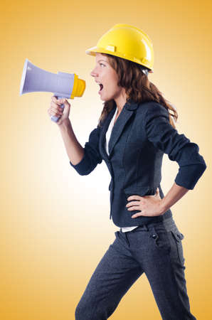 Female construction worker with loudspeakerの写真素材
