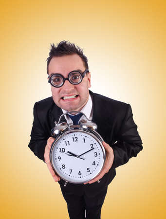 Businessman with clock against the gradientの写真素材