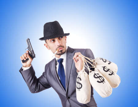 Businessman criminal with sacks of moneyの写真素材