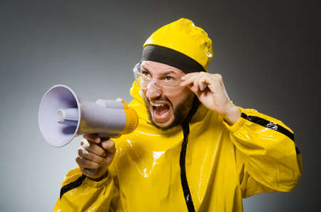 Man wearing yellow suit with loudspeakerの写真素材