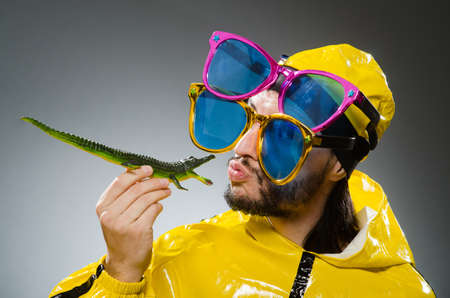 Man wearing yellow suit in funny conceptの写真素材