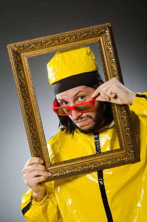 Man wearing yellow suit with picture frame