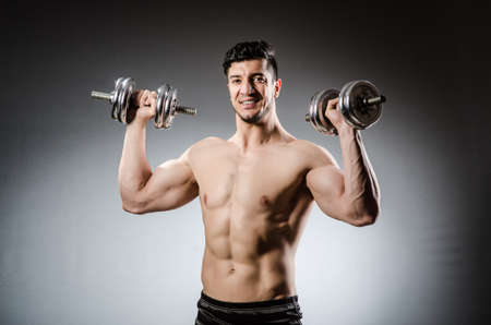 Muscular ripped bodybuilder with dumbbellsの写真素材