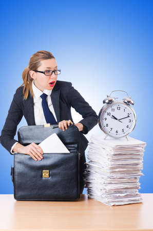 Woman businesswoman with giant alarm clockの写真素材