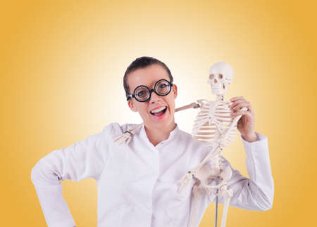 Doctor with skeleton against gradientの写真素材