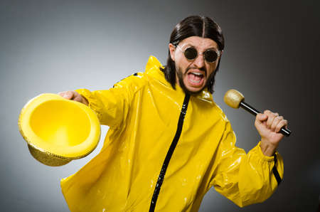 Man wearing yellow suit with mic