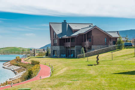 Modern house near water on bright dayの写真素材
