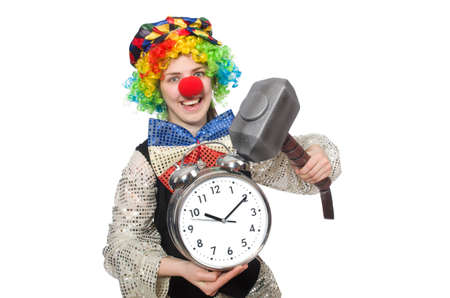Female clown with alarm-clock and hammer isolated on whiteの写真素材