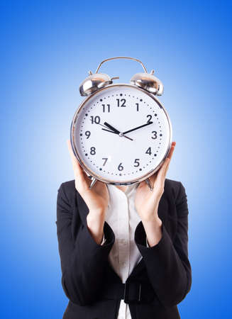 Woman businesswoman with giant clockの写真素材