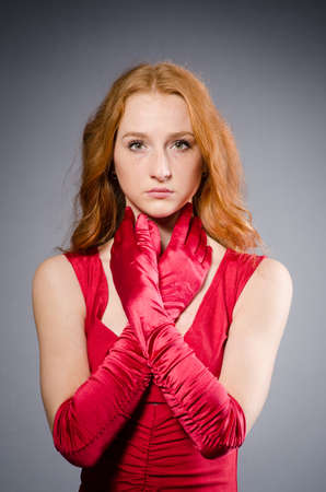Pretty young girl in red dress isolated on whiteの写真素材