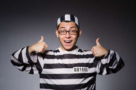 Funny prisoner isolated on grayの写真素材