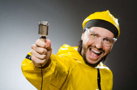 Man wearing yellow suit with mic