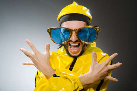 Man wearing yellow suit in funny conceptの写真素材