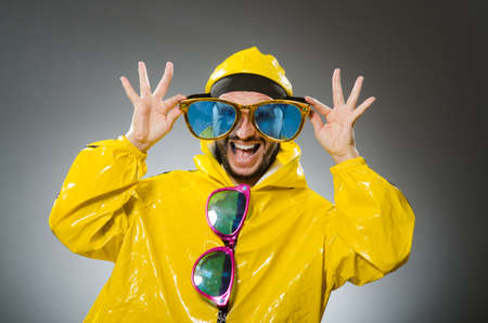Man wearing yellow suit in funny conceptの写真素材