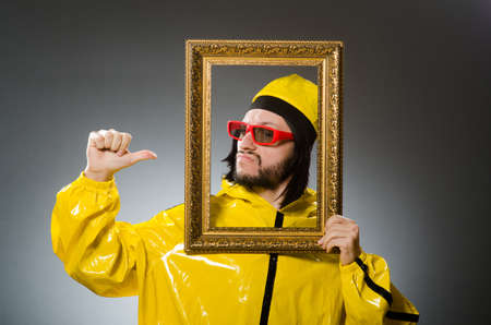 Man wearing yellow suit with picture frame