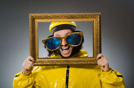 Man wearing yellow suit with picture frame