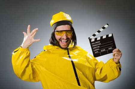 Man wearing yellow suit with movie boardの写真素材