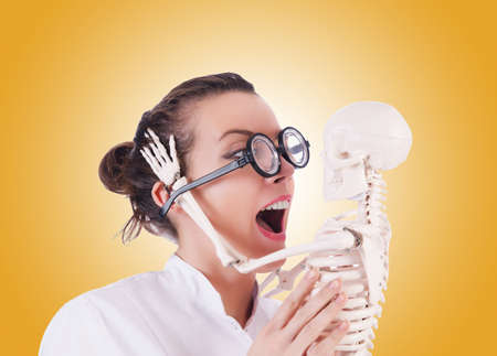 Doctor with skeleton against gradientの写真素材