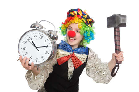Female clown with alarm-clock and hammer isolated on whiteの写真素材