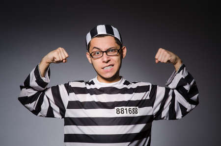 Funny prisoner isolated on grayの写真素材