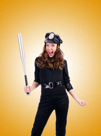 Police with bat against the gradientの写真素材