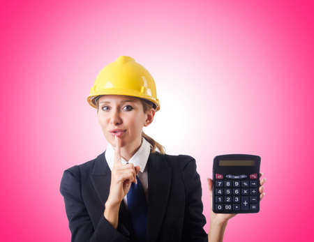 Female construction worker with calculatorの写真素材