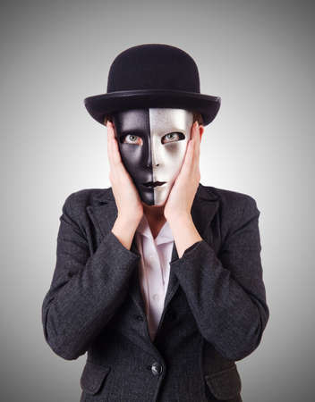 Woman with mask in hypocrisy conceptの写真素材