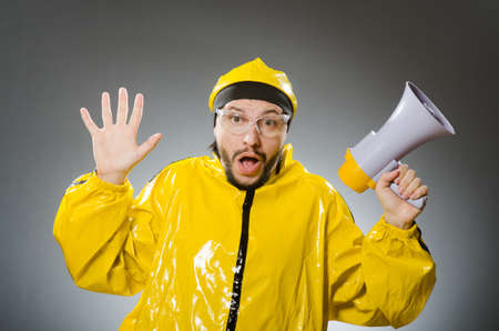 Man wearing yellow suit with loudspeaker