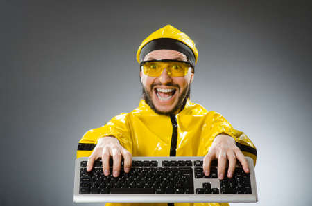 Man wearing yellow suit with keyboardの写真素材