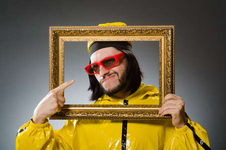 Man wearing yellow suit with picture frame