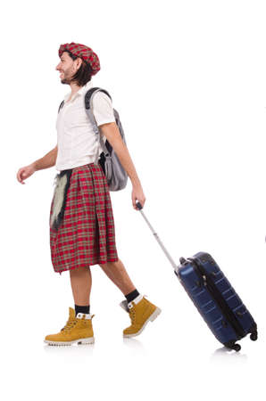 Man in scottish skirt with suitcase isolated on whiteの写真素材